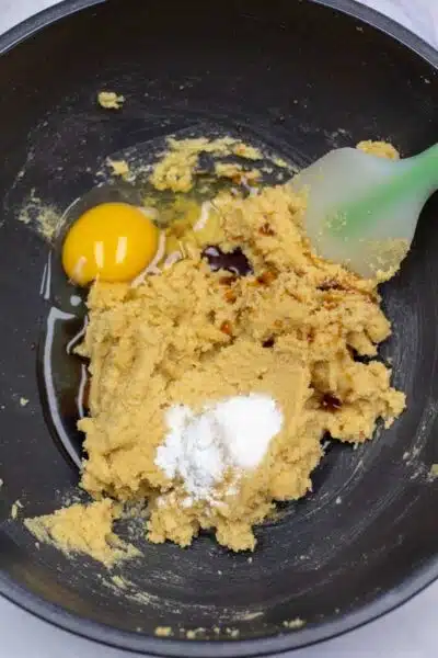 Process image 3 showing creamed sugars and butter in a mixing bowl with added egg.