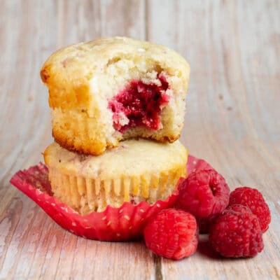 Square image of raspberry white chocolate muffins.