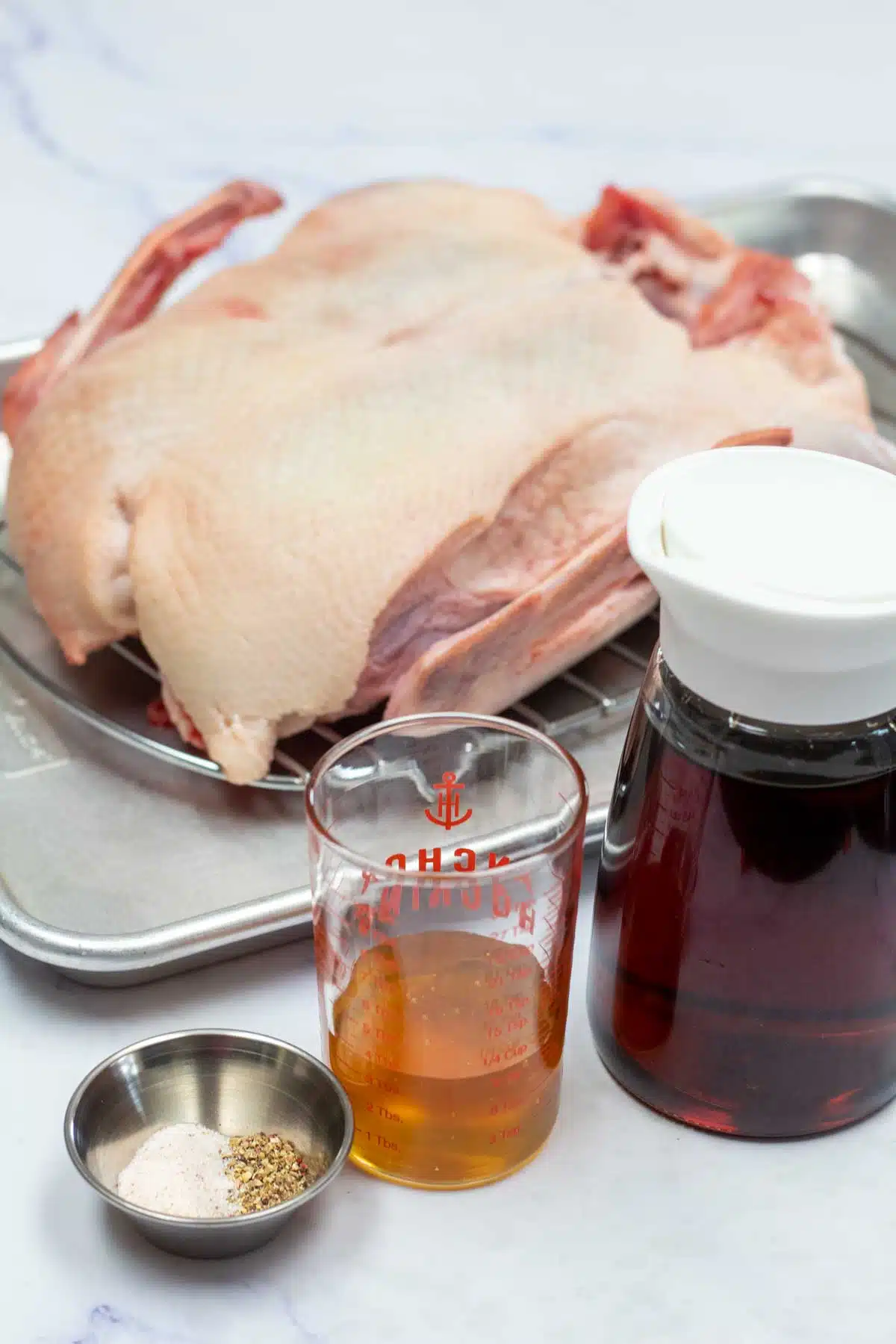 Tall image showing ingredients needed for smoked duck.