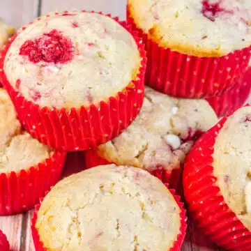 Wide image of raspberry white chocolate muffins.