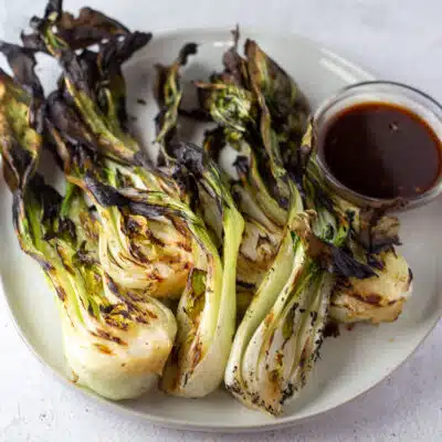 Square image showing grilled bok choy.