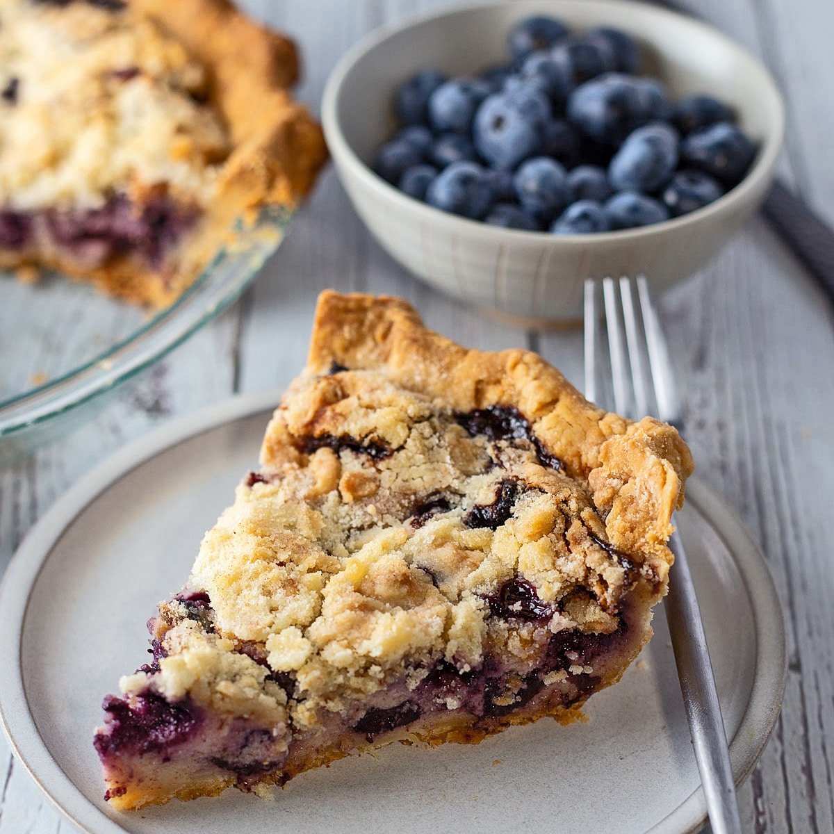 Square image of sour cream blueberry pie.