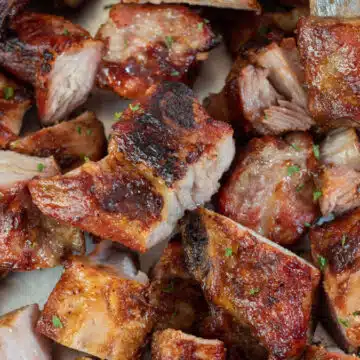 Wide image of grilled bbq pork rib tips.