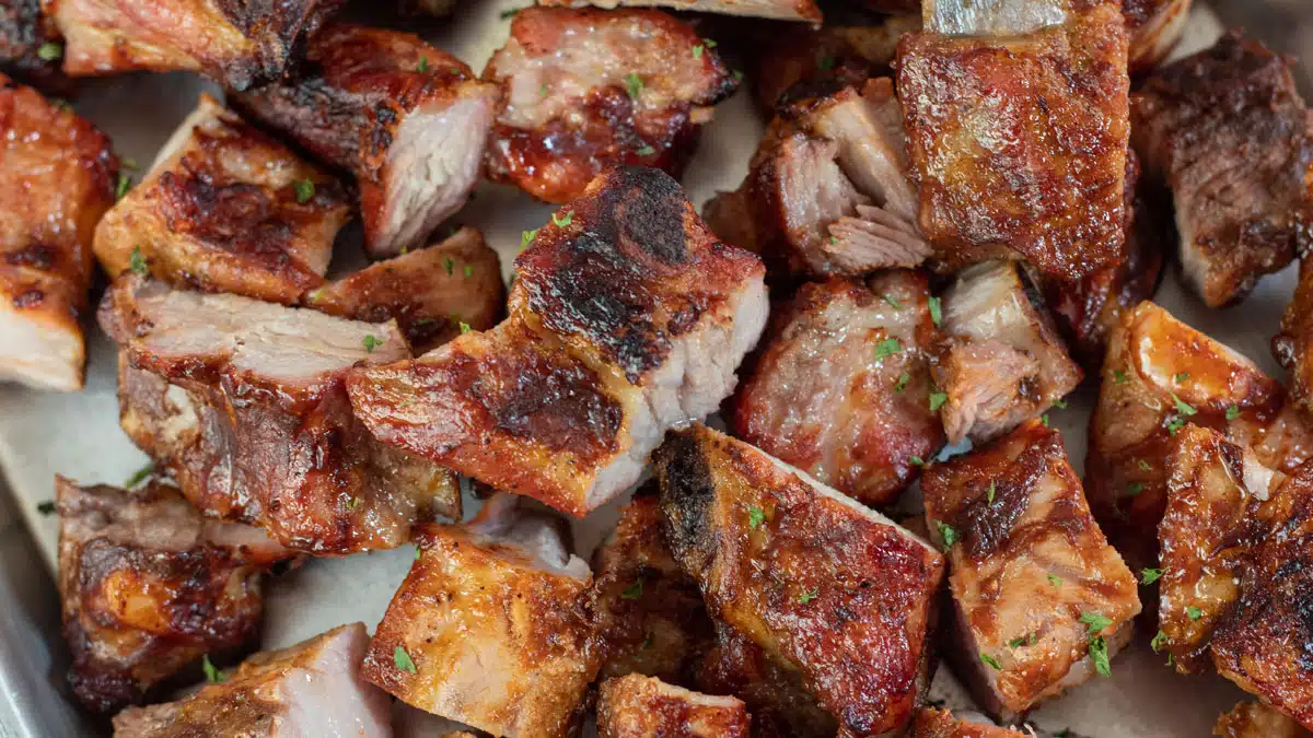 Wide image of grilled bbq pork rib tips.