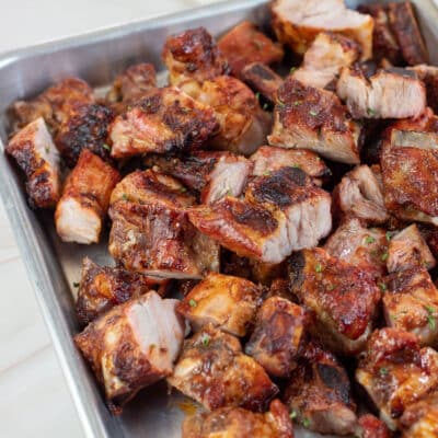 Square image of grilled bbq pork rib tips.