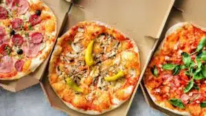 Wide image of pizzas.