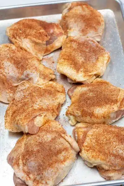 Process image 1 showing seasoned chicken thighs.