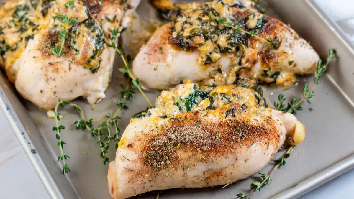 Wide image of spinach stuffed chicken breasts.