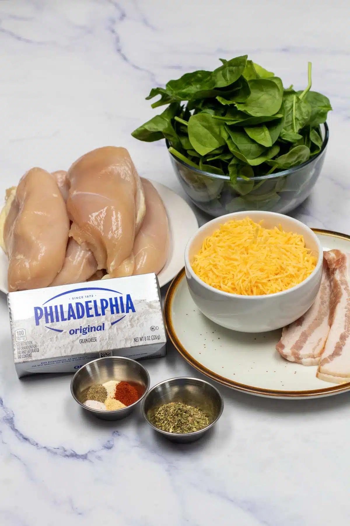 Tall image of spinach stuffed chicken breast ingredients.