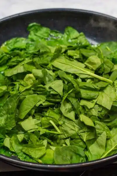 Process image 2 showing cooking chopped baby leaf spinach.