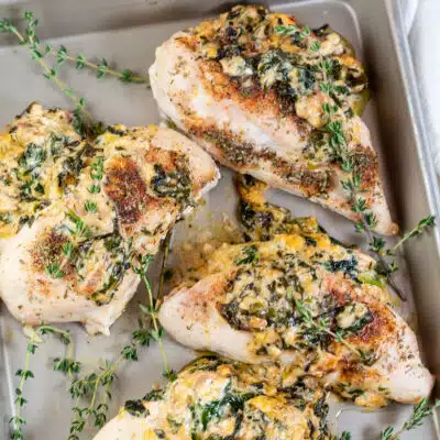 Square image of spinach stuffed chicken breasts.