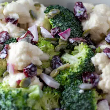 Wide image of broccoli cauliflower salad.