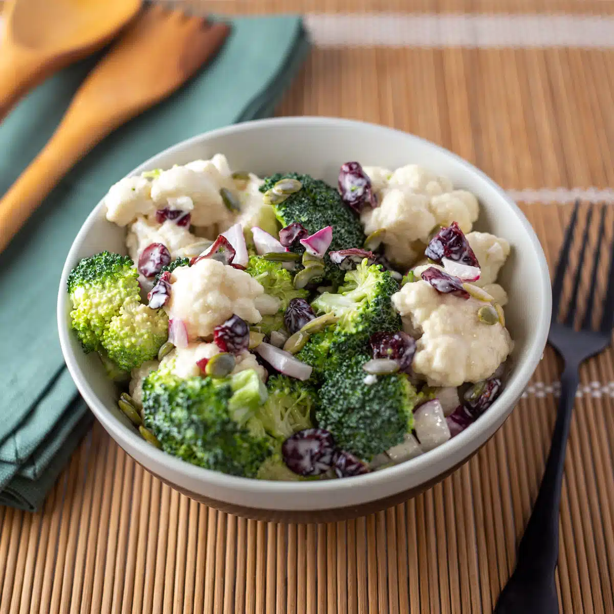 Square image of broccoli cauliflower salad.