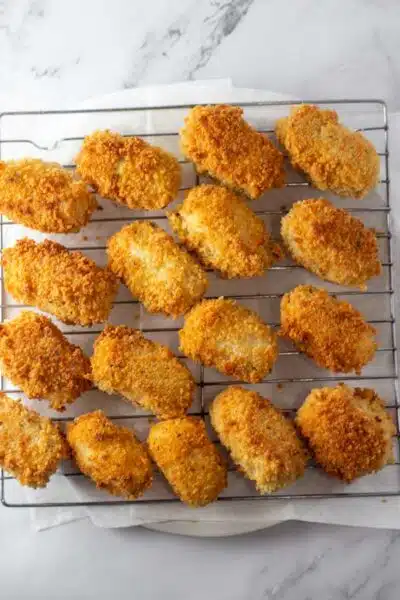 Process image 12 showing fried cheese croquettes on wire rack.