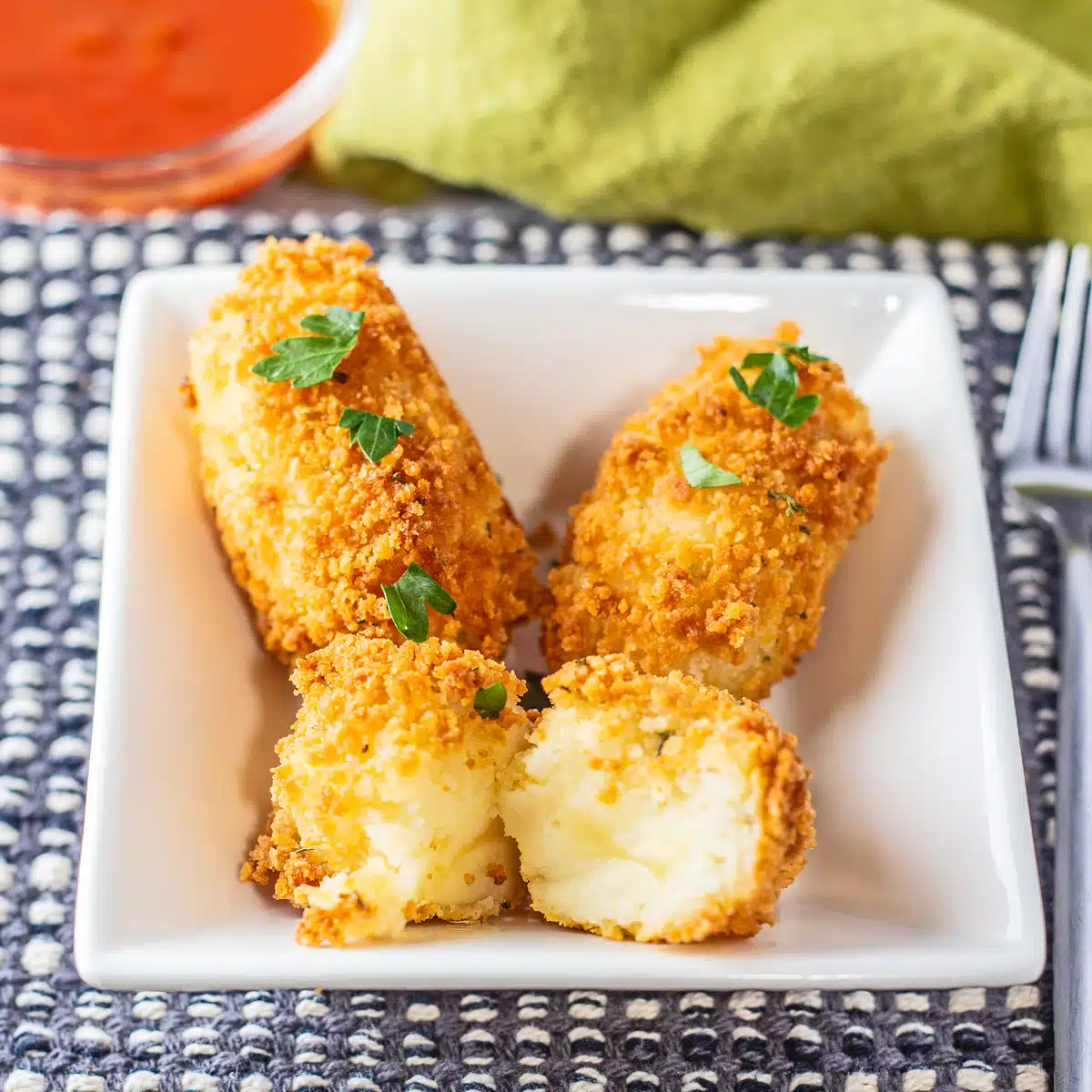 Square image of cheese croquettes.