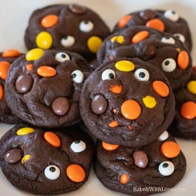 Square image of a pile of Chocolate Reese's Pieces halloween cookies.