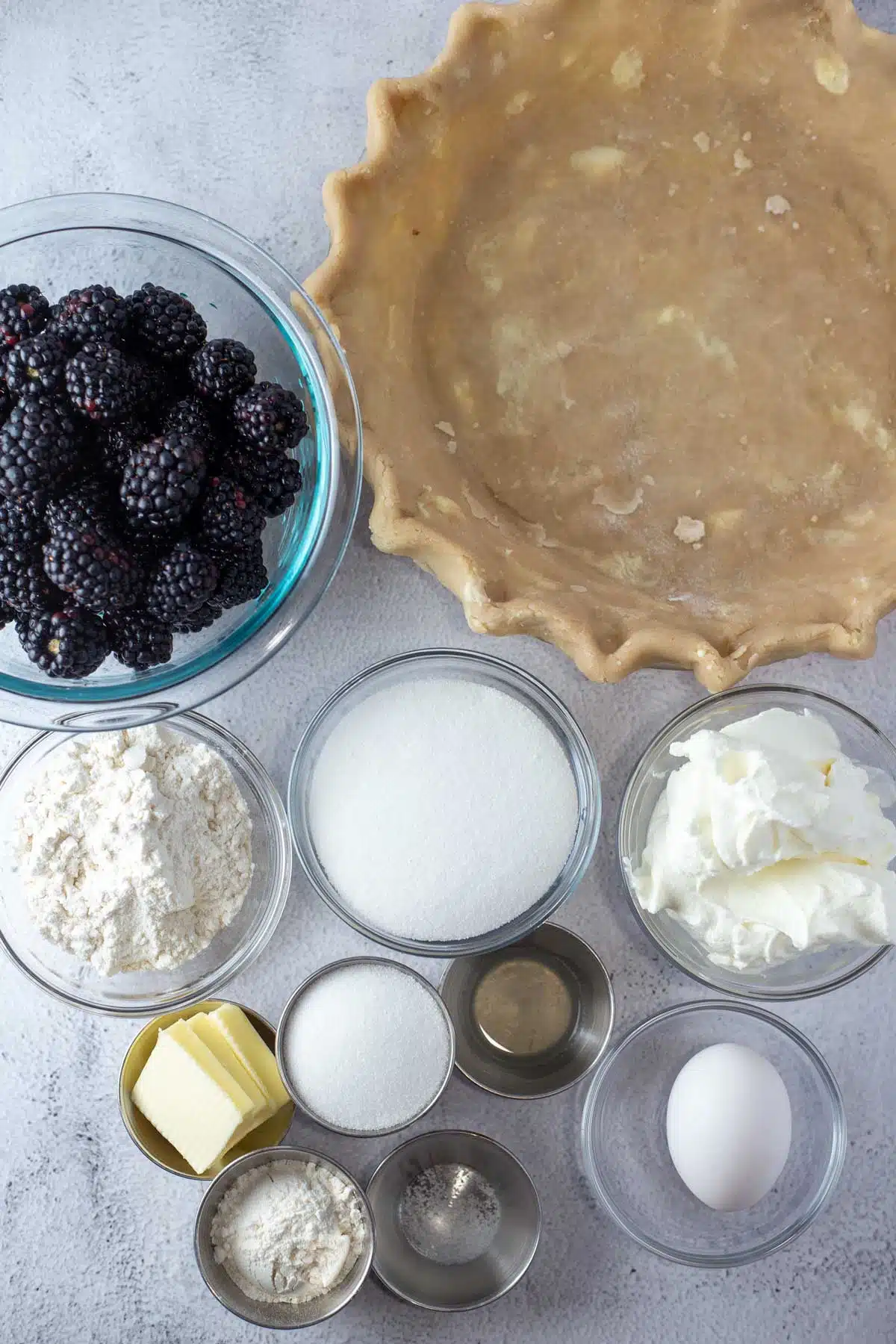 Tall image showing sour cream blackberry pie ingredients.