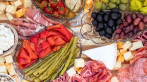 Wide close up image of antipasto platter, with mostly mixes of cheese and meat.