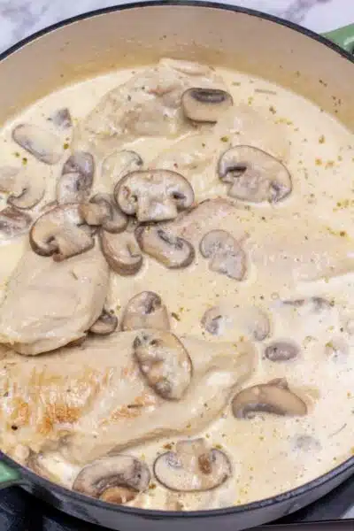 Process image 8 showing combined chicken, mushrooms, and Parmesan in sauce sauce.