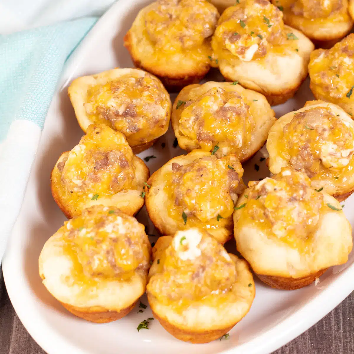 Square image showing sausage cream cheese biscuit bites.