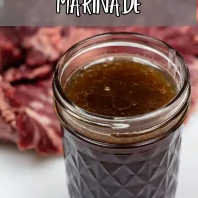 Pin image with text of skirt steak marinade in a glass jar.