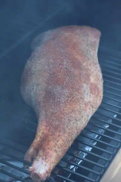 Process image 3 showing lamb leg in smoker.