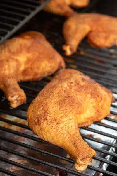 Process image 3 showing chicken leg quarters finished in smoker.