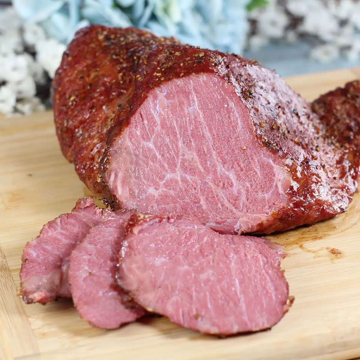 Square image showing smoked corned beef on a cutting board.