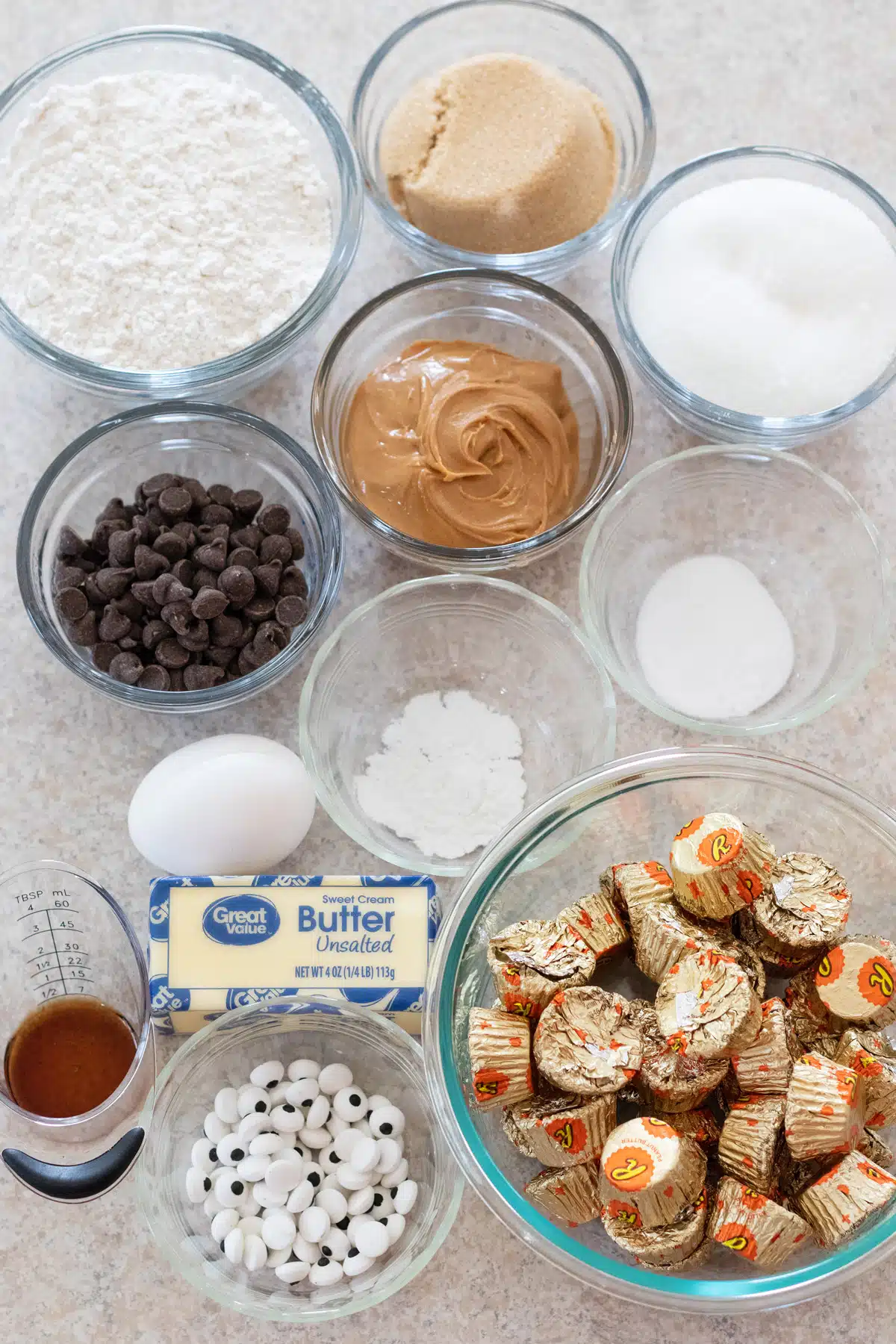 Tall image showing ingredients needed for Halloween peanut butter spider cookies.