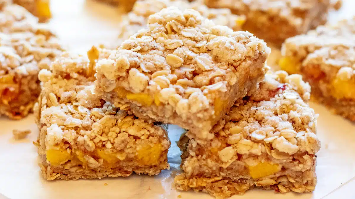 Wide image of peach crumble bars.