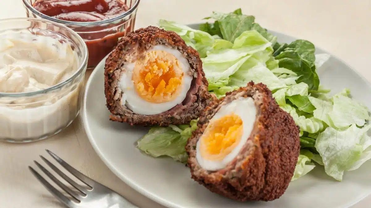 Wide image of baked scotch eggs.