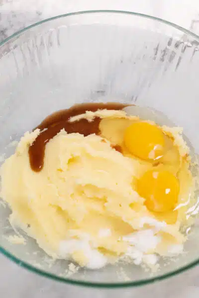 Process image 2 showing creamed butter and sugar in a mixing bowl with added eggs and vanilla.
