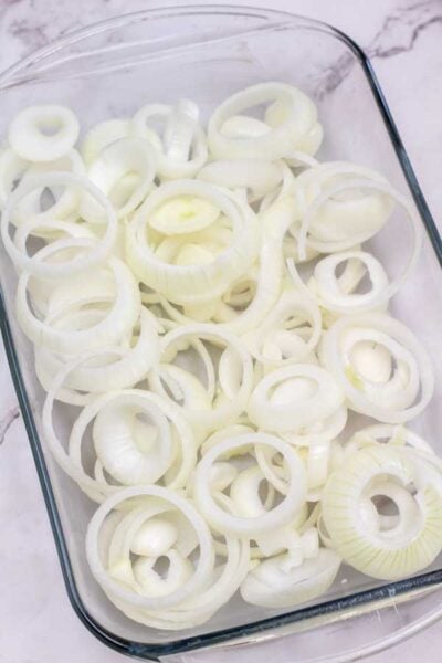 Process image 1 showing sliced onions in a glass baking dish.