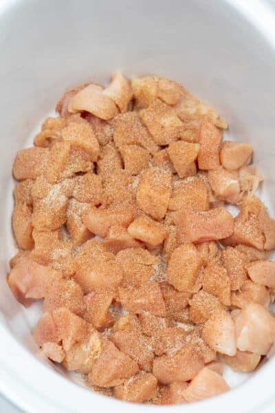 Process image 2 showing seasoned chicken in crockpot.