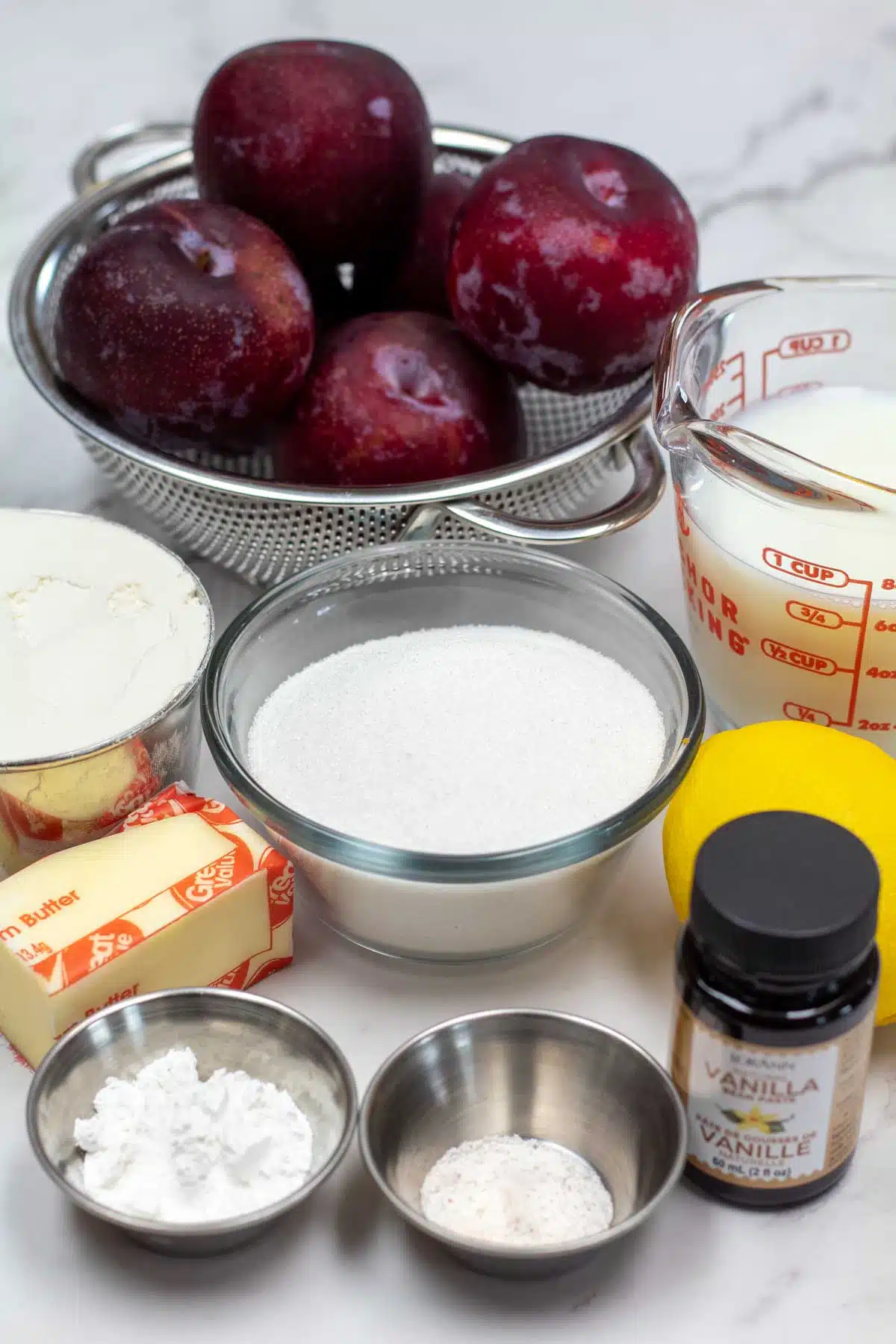 Tall image showing ingredients needed for plum cobbler.