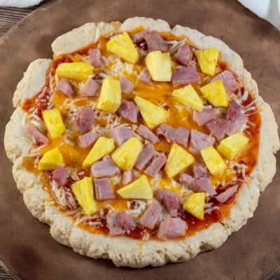 Square image showing a Hawaiian style pizza made on a 2 ingredient pizza dough crust.