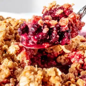 Best blackberry crisp recipe spooned out of baking dish and ready to serve.