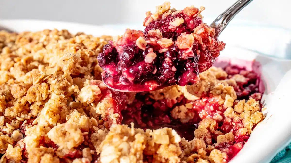 Best blackberry crisp recipe spooned out of baking dish and ready to serve.