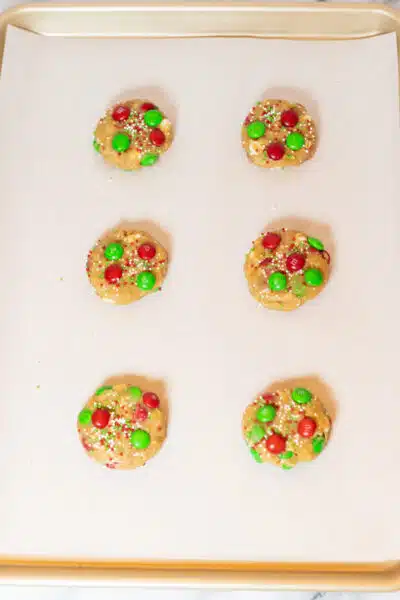 Process image 9 showing pressed down cookie dough with added M&Ms.