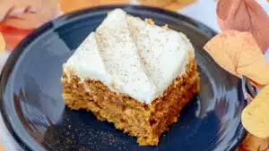 Wide bar image of pumpkin bars with cream cheese frosting.
