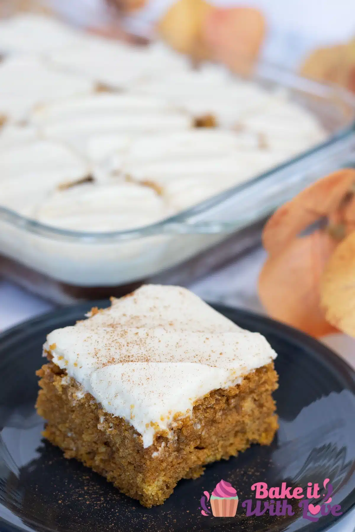 Tall image of pumpkin bars with cream cheese frosting.