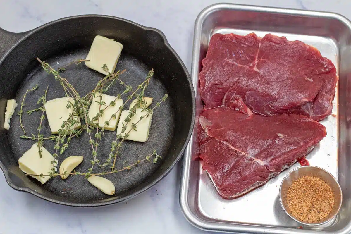 Wide image of ingredients needed for grilled ostrich steaks.