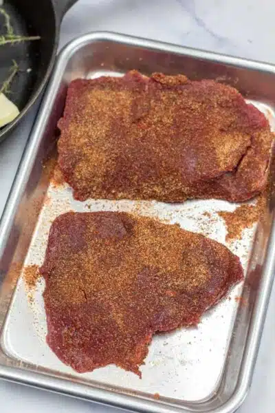 Process image 1 showing seasoned ostrich steaks.