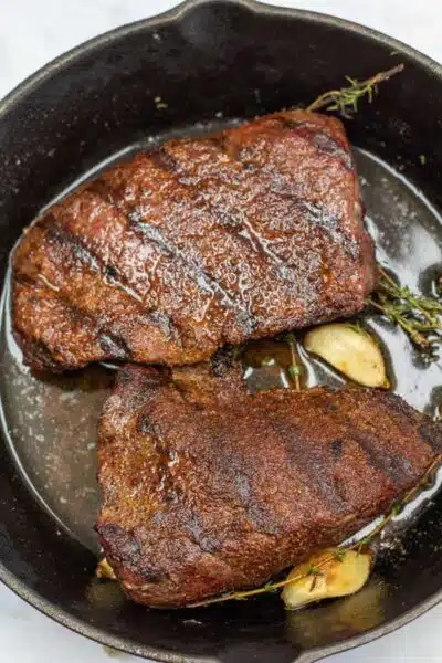 Process image 6 showing resting ostrich steaks in herb butter.