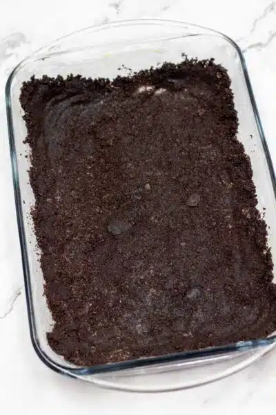 Process image 3 - press Oreo crust layer in baking dish.