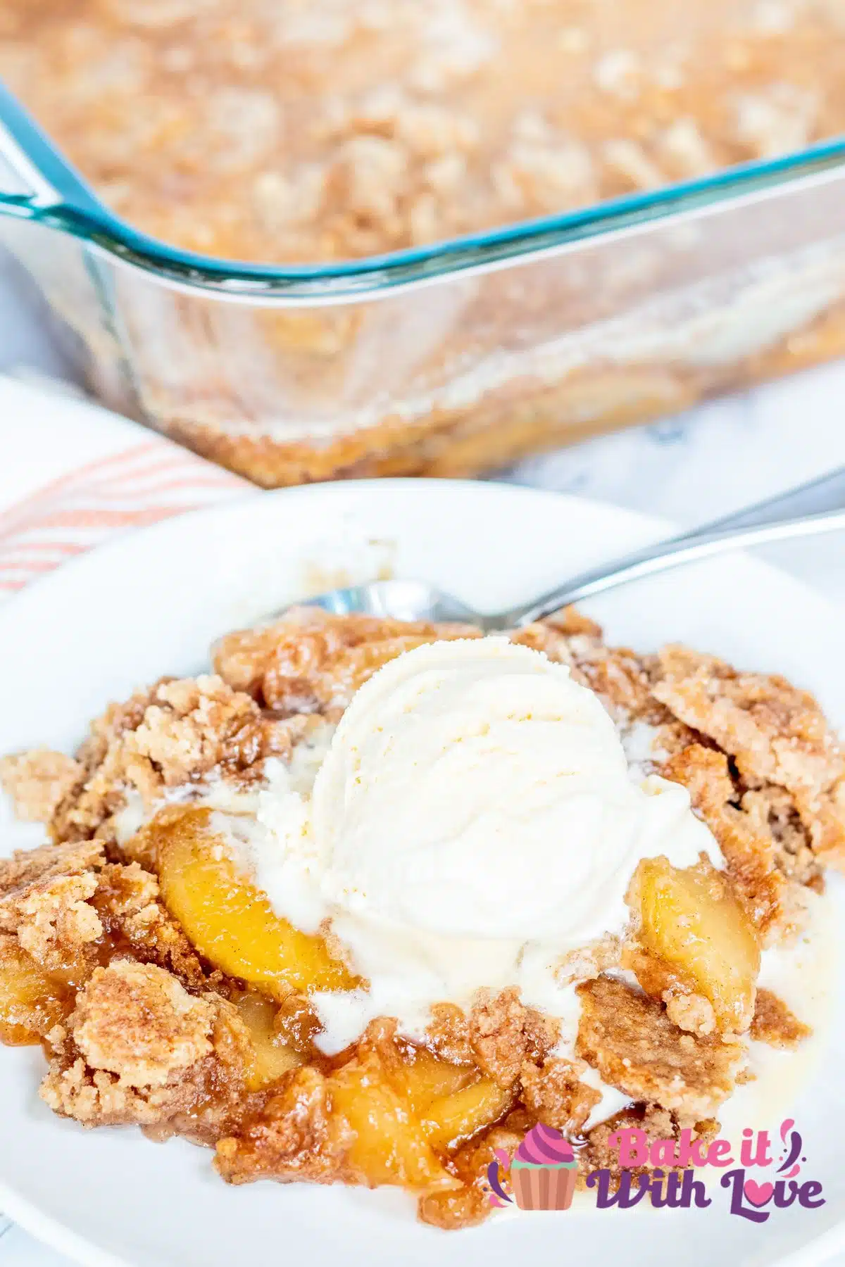 Tall image of apple snickerdoodle dump cake with ice cream.