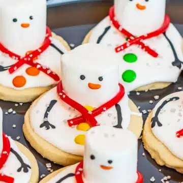 Wide image showing melting snowman sugar cookies.