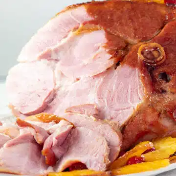 Wide image of sliced baked holiday ham.