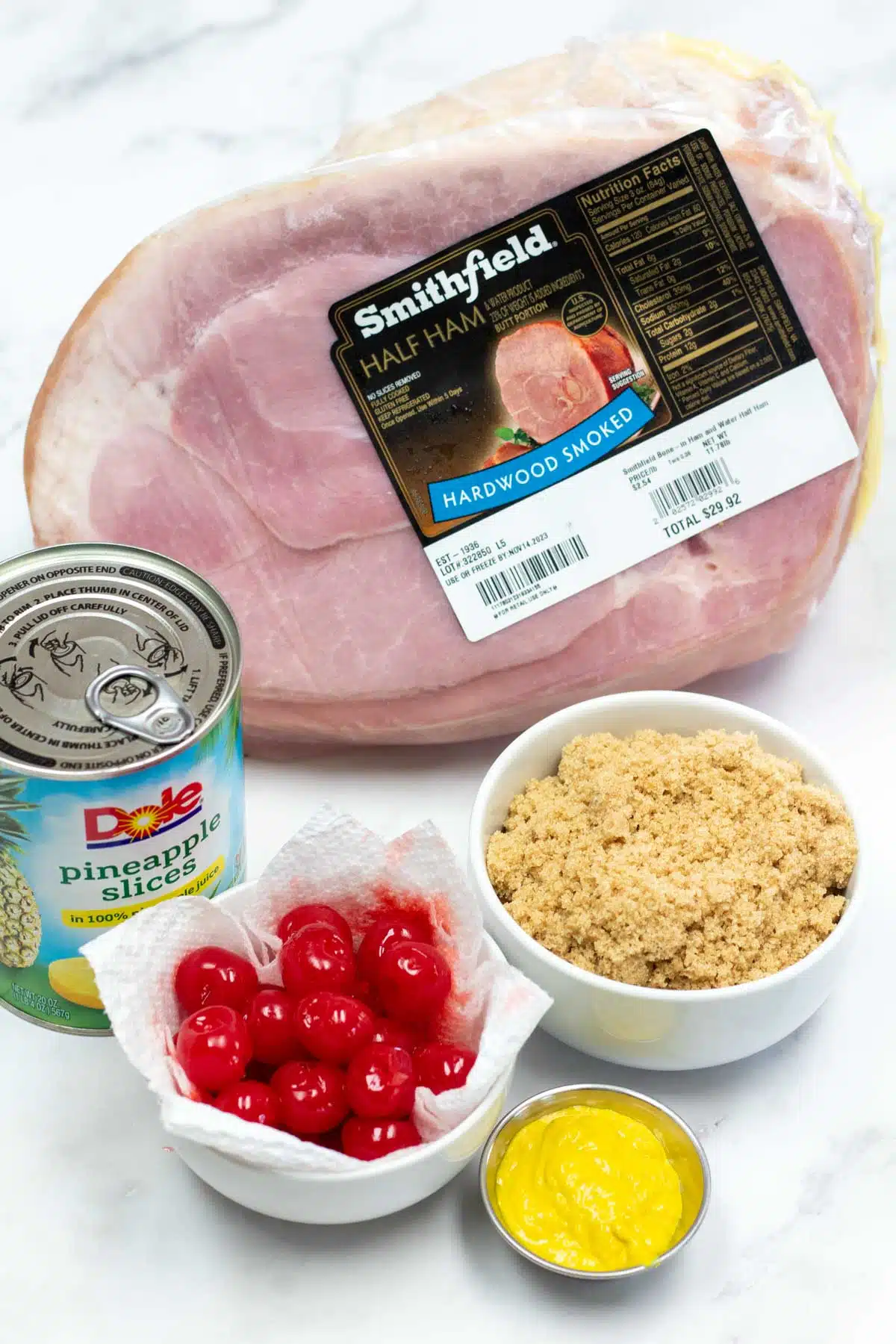 Tall image of ingredients needed for making this baked holiday ham.