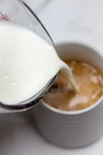 Process image 7 showing making the latte, adding milk.